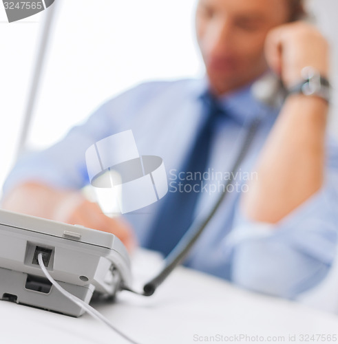 Image of handsome businessman talking on the phone