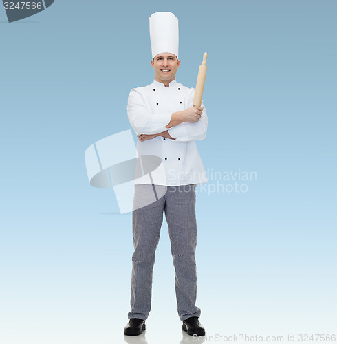 Image of happy male chef cook holding rolling pin