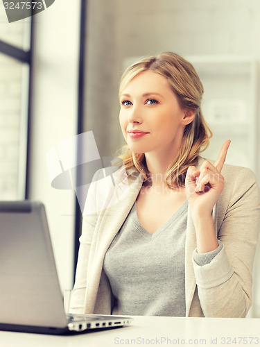 Image of woman with laptop and finger up