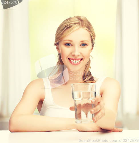 Image of young smiling woman with glass of water