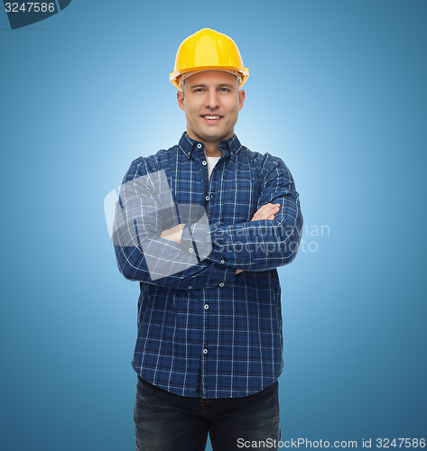 Image of smiling male builder or manual worker in helmet