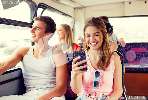 Image of smiling couple with smartphone making selfie