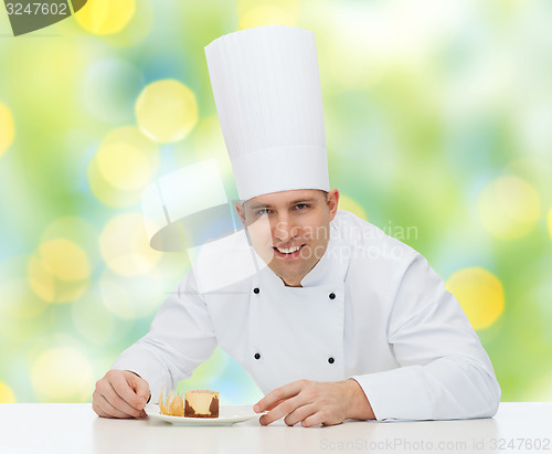 Image of happy male chef cook decorating dessert