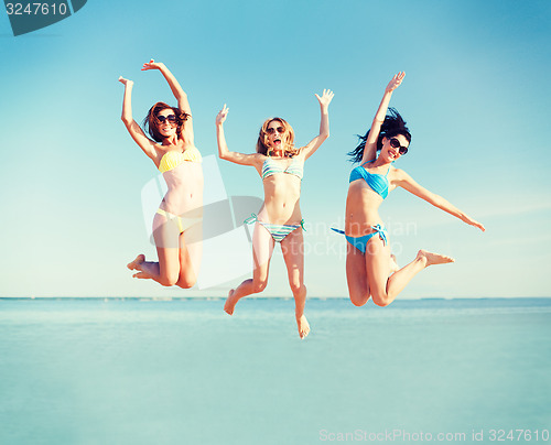 Image of girls jumping on the beach