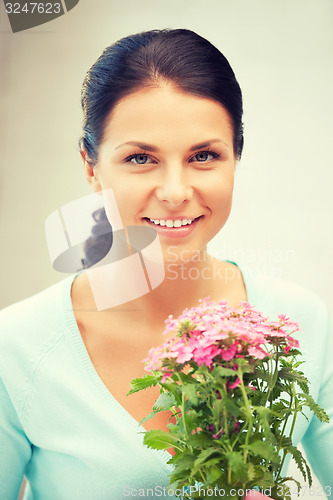 Image of lovely housewife with flower