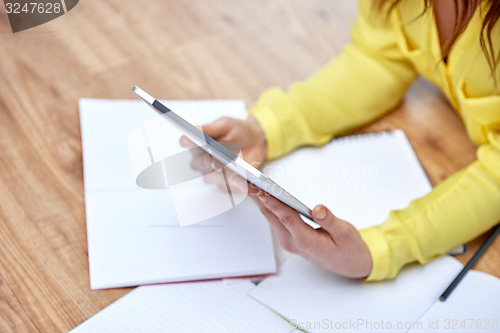 Image of close up of female hands with tablet pc