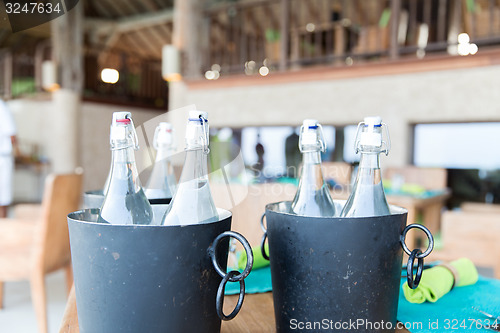 Image of bottles of water in ice bucket at hotel restaurant