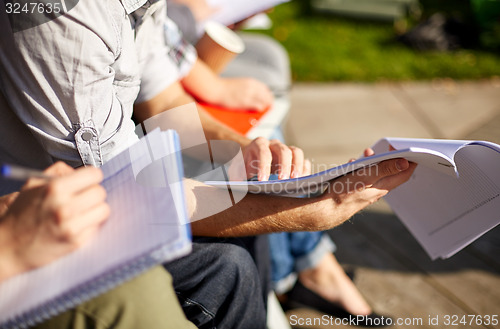 Image of close up of students with notebooks at campus