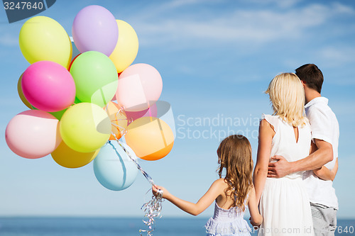 Image of family with colorful balloons