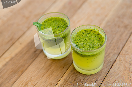 Image of glasses of fresh juice or cocktail on beach