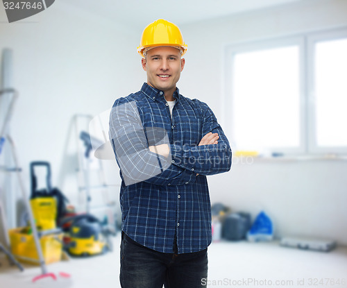 Image of smiling male builder or manual worker in helmet