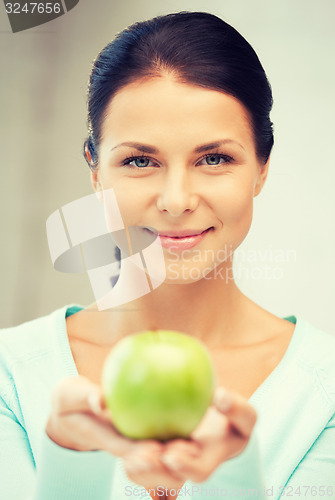 Image of lovely housewife with green apple