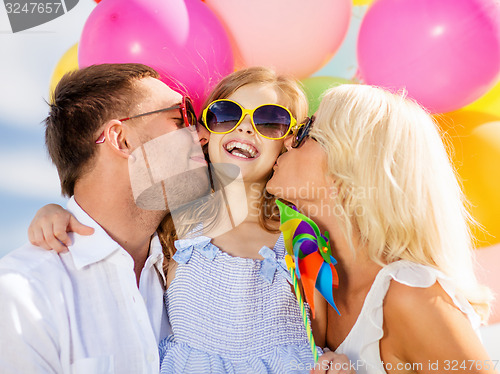 Image of family with colorful balloons