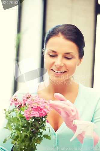 Image of lovely housewife with flower