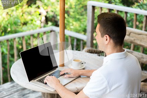 Image of close up of businessman with laptop on terrace