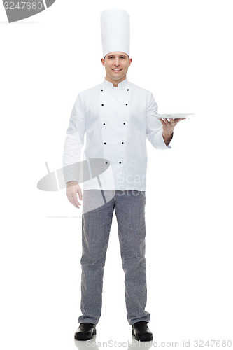 Image of happy male chef cook showing empty plate