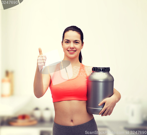 Image of teenage girl with jar of protein showing thumbs up