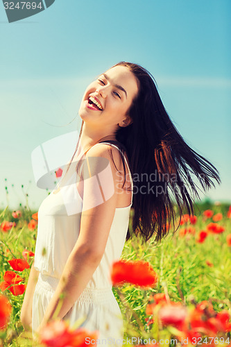 Image of laughing young woman on poppy field