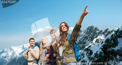 Image of group of smiling friends with backpacks hiking