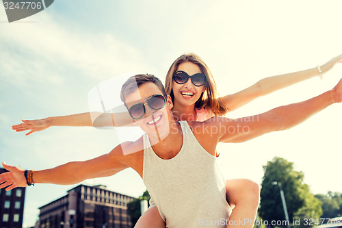 Image of smiling couple having fun in city