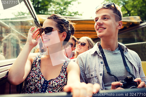 Image of smiling couple with camera traveling by tour bus