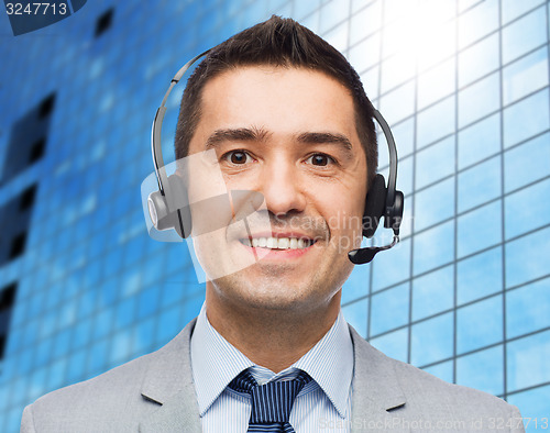 Image of smiling businessman in headset