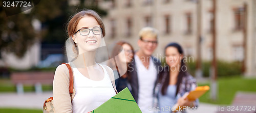 Image of happy teenage students with school folders