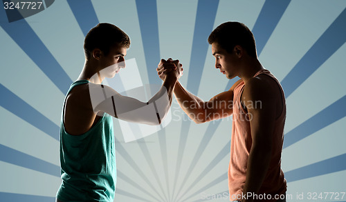 Image of two young men arm wrestling