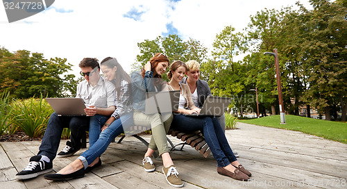 Image of students or teenagers with laptop computers