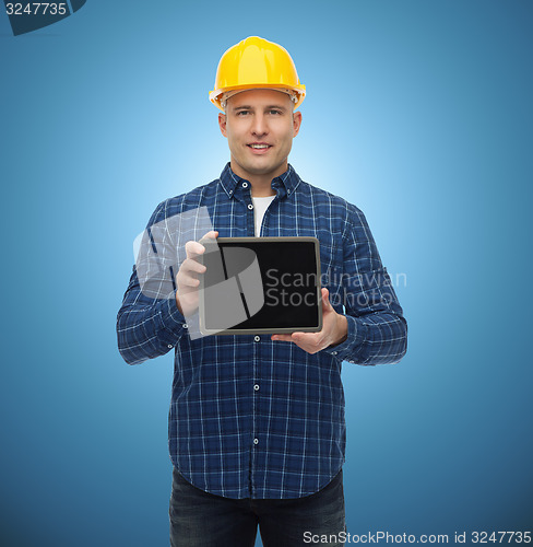 Image of smiling male builder in helmet with tablet pc