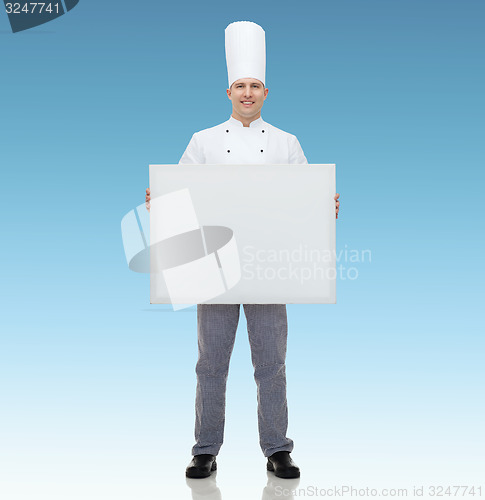 Image of happy male chef cook holding white blank big board