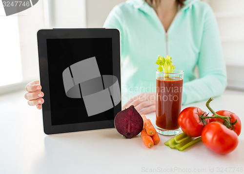 Image of close up of woman with tablet pc and vegetables