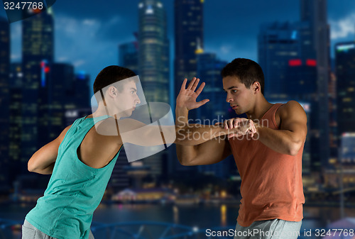 Image of young men fighting hand-to-hand