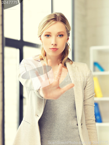 Image of young woman making stop gesture