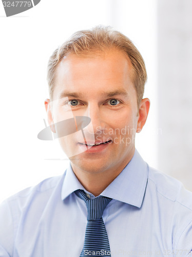 Image of smiling businessman in office
