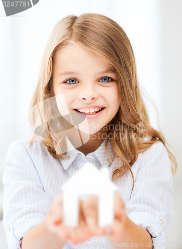 Image of girl holding white paper house