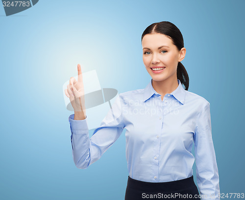 Image of businesswoman touching something imaginary