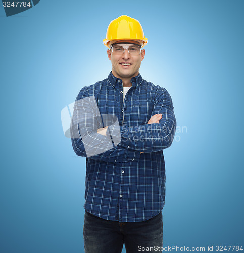 Image of smiling male builder or manual worker in helmet