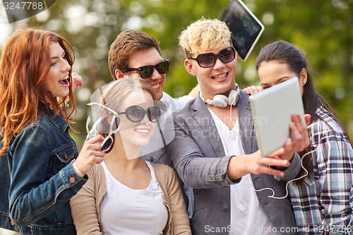 Image of students or teenagers with tablet pc taking selfie