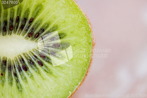 Image of close up of ripe kiwi slice on table