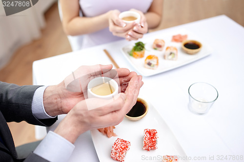 Image of close up of couple drinking tea at restaurant