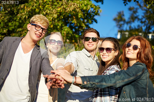 Image of group of students or teenagers with hands on top