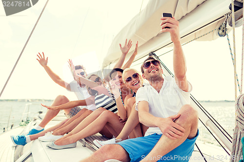 Image of smiling friends sitting on yacht deck