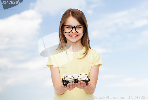 Image of smiling cute little girl in black eyeglasses