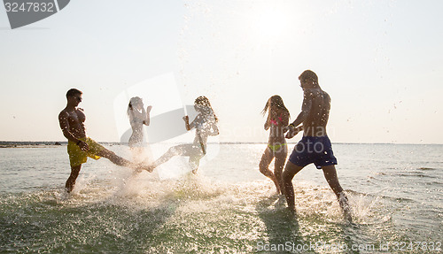 Image of happy friends having fun on summer beach