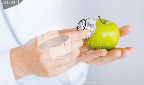 Image of male doctor with green apple and stethoscope