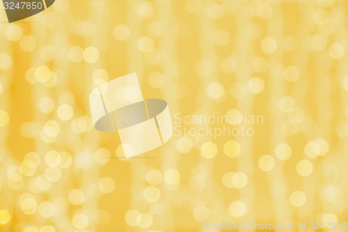 Image of blurred golden background with bokeh lights