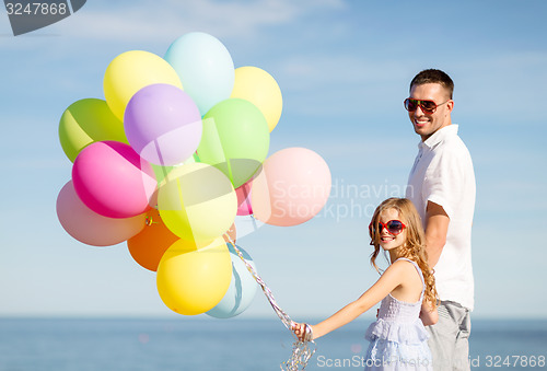Image of happy father and daughter with colorful balloons