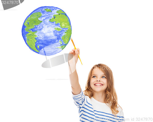 Image of cute little girl drawing with brush planet earth