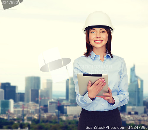 Image of young smiling businesswoman in white helmet